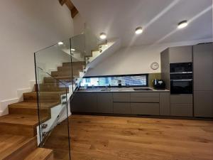 a kitchen with a staircase and a kitchen with wooden floors at Apartment in Cerny Dul near Ski Resort in Cerny Dul +13 photos