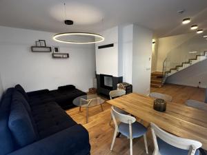 a living room with a blue couch and a wooden table at Apartment in Cerny Dul near Ski Resort in Cerny Dul