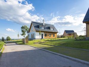 a house with a black roof and a driveway at Chalet in istá near Ski Slopes in Cerny Dul +20 photos