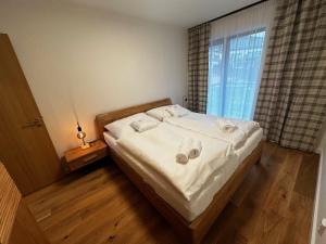a bedroom with a bed with towels on it at Apartment in Cerny Dul near SkiResort in Cerny Dul