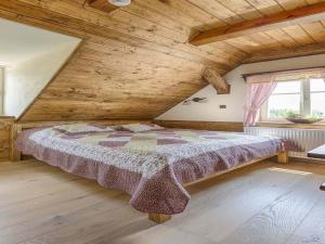 a bedroom with a large bed in a wooden ceiling at Chalet in Liberec near Ski Resort Jested in Světlá pod Ještědem
