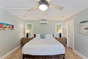 a bedroom with a bed and a ceiling fan at AV4-22: 4 22nd Avenue in Isle of Palms +39 photos