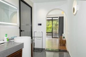 a bathroom with a sink and a refrigerator at 凤凰苇渡庭院江景民宿 in Fenghuang +139 photos