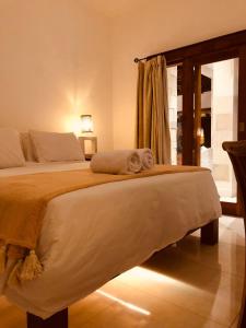 a bedroom with a bed with a towel on it at Villa Dunia - 400M Private Villa Walk to Beach Top location Gili Trawangan in Gili Trawangan