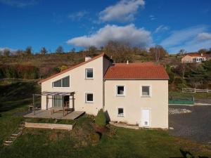 a white house with a red roof at Chambre cosy avec terrasse et jardin proche Puy-en-Velay - FR-1-582-526 in Saint-Germain-Laprade