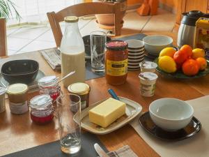a table with cheese and other food items on it at Chambre cosy avec terrasse et jardin proche Puy-en-Velay - FR-1-582-526 in Saint-Germain-Laprade +16 photos