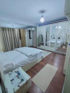 a bedroom with a large bed and a large mirror at شقق Hs 4 in Cairo +35 photos