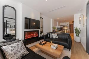 a living room with a couch and a fireplace at The Zénith, by Harry's in Hanoi