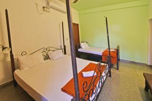 a room with two beds in a room at Villa close to Rock beach-Family Room in Puducherry