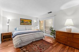 a white bedroom with a bed and a window at Lake Escape in Carnelian Bay +32 photos