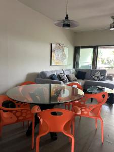 a living room with a couch and a table and chairs at Grand Baie Domaine des Alizées Club & Spa in Grand Baie