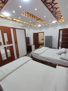a bedroom with two beds in a room at Seuiet Hs شهاب in Cairo