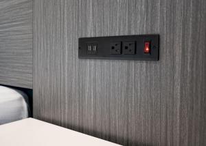 a lightswitch on a wall next to a bed at La Mirage Inn - Long Beach in Long Beach +5 photos