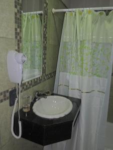 a bathroom with a sink and a shower curtain at Apartamento Brisas del Golf in Colón