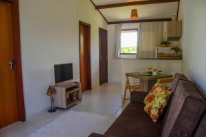 a living room with a couch and a table at Quinta Do Rio - ePipa in Pipa