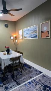 a dining room with a table and a ceiling fan at Humaira Homestay Teluk Intan in Teluk Intan