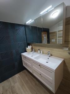 a bathroom with a white sink and a mirror at La Mansarda in San Cesareo