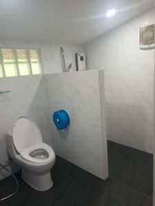 a bathroom with a toilet with a blue toilet paper dispenser at Saen Kam Resort in Ban Tham +51 photos