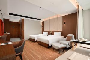 Vuode tai vuoteita majoituspaikassa 滨江万璟酒店 One Gem Hotel