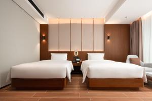 Vuode tai vuoteita majoituspaikassa 滨江万璟酒店 One Gem Hotel