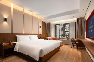 Vuode tai vuoteita majoituspaikassa 滨江万璟酒店 One Gem Hotel