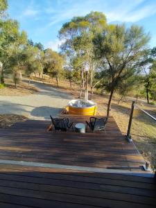 a wooden deck with two chairs and a fountain at Valley Views Retreat in Richmond