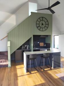 a kitchen with a large counter and a clock on the wall at Valley Views Retreat in Richmond