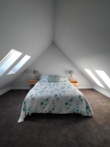 a bedroom with a bed and two night stands in a attic at Valley Views Retreat in Richmond