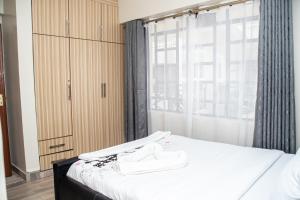 Postel nebo postele na pokoji v ubytování Cosy Flamingo furnished apartments