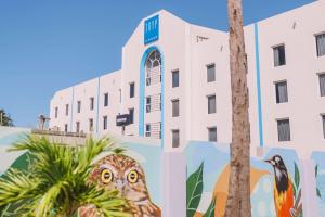 a mural of an owl in front of a building at TRYP by Wyndham Aruba in Palm-Eagle Beach