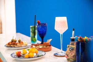 a table with three plates of food and a wine glass at TRYP by Wyndham Aruba in Palm-Eagle Beach