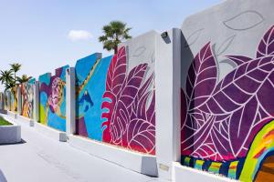 a wall with a mural of plants at TRYP by Wyndham Aruba in Palm-Eagle Beach