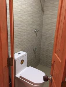 a bathroom with a toilet and a shower at Light House Residence in Dondra West