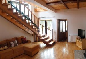 a living room with a couch and stairs at Villa Roksolana in Truskavets