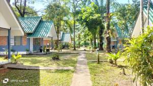 a path in front of a house with trees at Alanta aonang resort in Ban Khlong Haeng