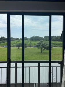 a view of a field from a window at Millennial Minimalist haven in Durban
