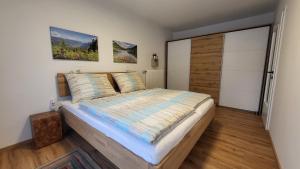 a bedroom with a bed and a sliding glass door at Appartements MAYR inklusive ganzjährig GRATIS Zugang zur ALPENTHERME und im SOMMER kostenlose Bergbahnnutzung in Bad Hofgastein +36 photos