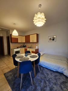 a bedroom with a bed and a table and chairs at Αγροικία Mυλόδεση in Kalavrita +24 photos