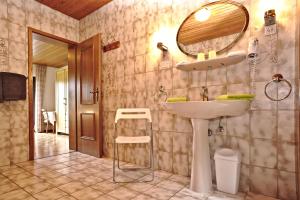 a bathroom with a sink and a mirror on the wall at Hotel-Restaurant Im Heisterholz in Hemmelzen +107 photos