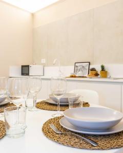 a table with wine glasses and a plate on it at Monti Nonna Francesca - ZENO 49 in Rome +15 photos