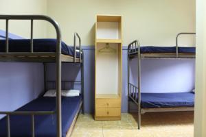 Postel nebo postele na pokoji v ubytování Casa de Colònies Vall de Boí - Verge Blanca