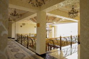 a room with a balcony with a chandelier at Said Islom Khoja in Khiva