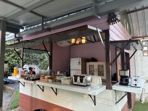 an outdoor kitchen with a counter with appliances at Pan Din Boutique Guest House in Phra Nakhon Si Ayutthaya