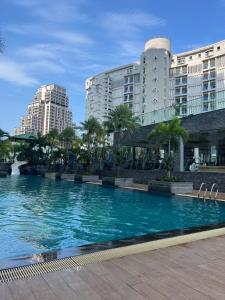 a large swimming pool in front of a building at Stunning Unit situated in Pattaya in Pattaya South