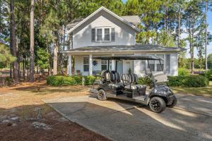 a golf cart parked in front of a house at 1369 Laurel Grove "The Crows Nest" in Destin