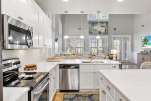 a kitchen with white cabinets and stainless steel appliances at 1369 Laurel Grove "The Crows Nest" in Destin
