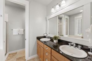 a bathroom with two sinks and a large mirror at 1369 Laurel Grove "The Crows Nest" in Destin