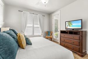 a bedroom with a bed and a television on a dresser at 1369 Laurel Grove "The Crows Nest" in Destin