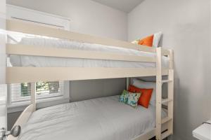 a bedroom with two bunk beds and a window at 1369 Laurel Grove "The Crows Nest" in Destin