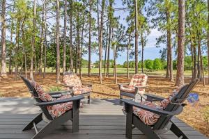 three chairs sitting on a boardwalk with trees in the background at 1369 Laurel Grove "The Crows Nest" in Destin